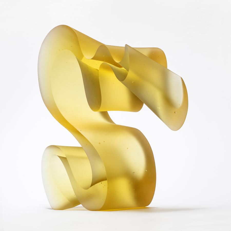 yellow standing curling line sculpture handmade from cast glass