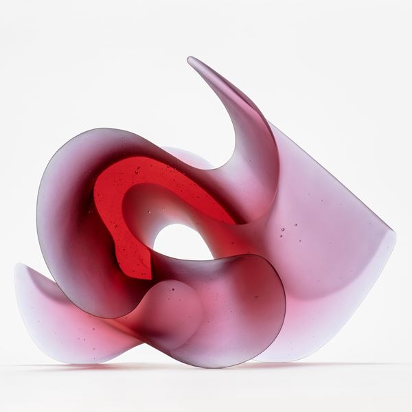 pink big curling and undulating ambiguous sculpture handmade from glass