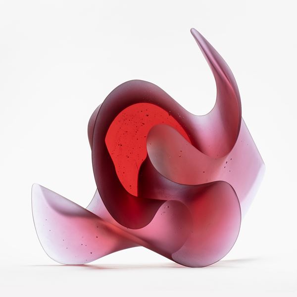 pink big curling and undulating ambiguous sculpture handmade from glass