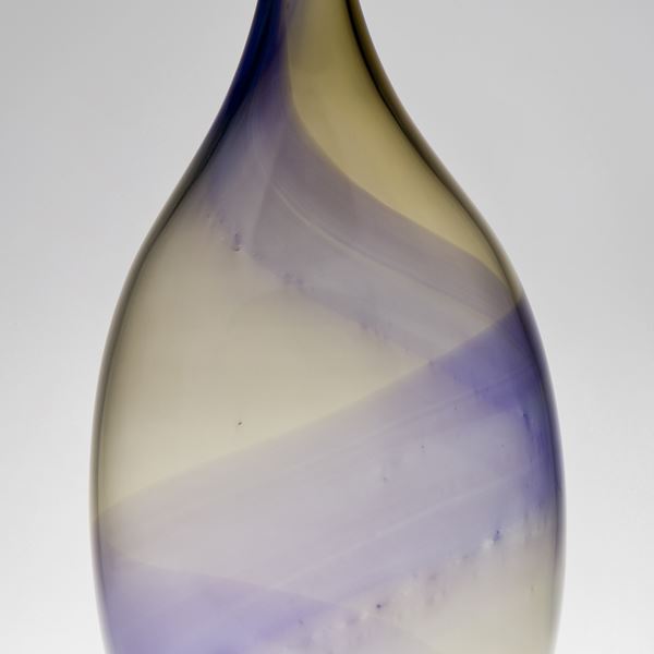 purple and amber swirling stripes of colour around a long necked bottle handmade from glass