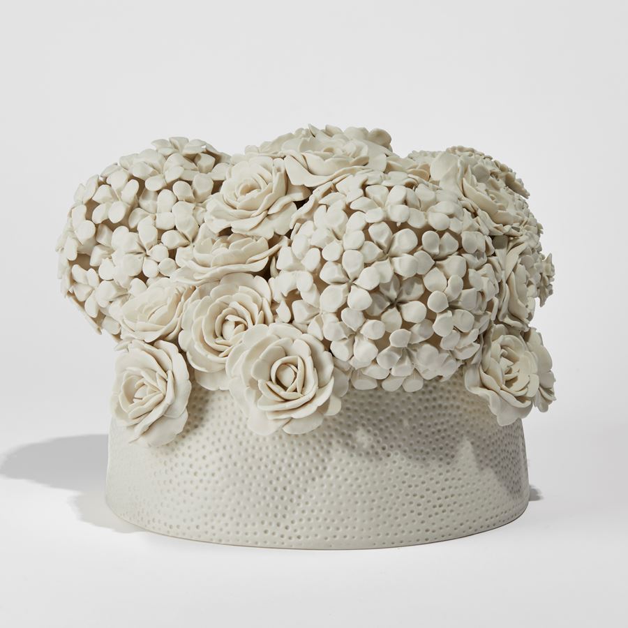 cream floral centrepiece with circular dotted base hand made from porcelain