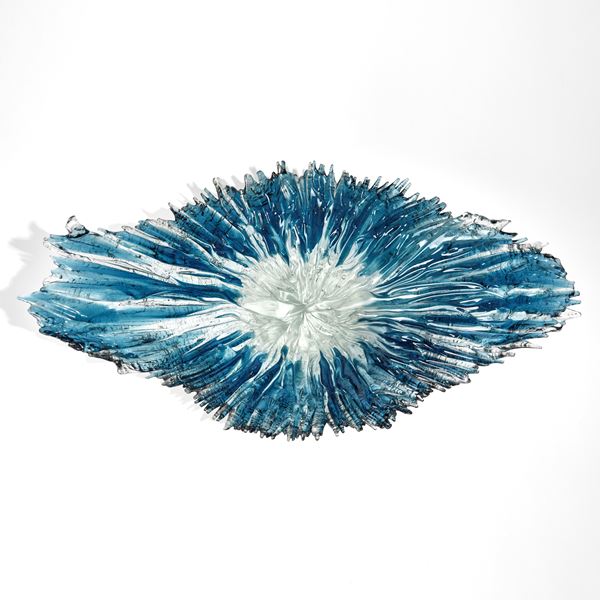 aqua and blue curved organic hand made glass bowl with the appearance of a wave