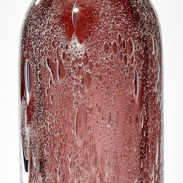 tall rounded top sculpture in aubergine with trapped effervescent bubbles hand made from glass