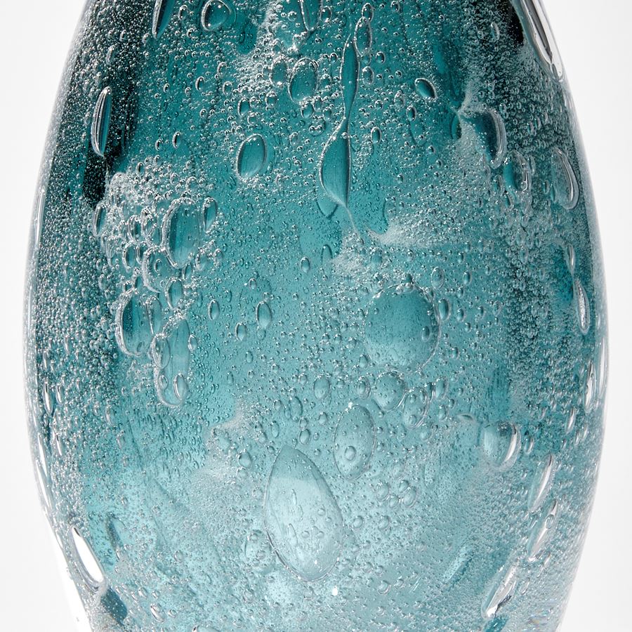 dark aqua and sea green tall pointed sculpture with trapped bubbles hand made from glass