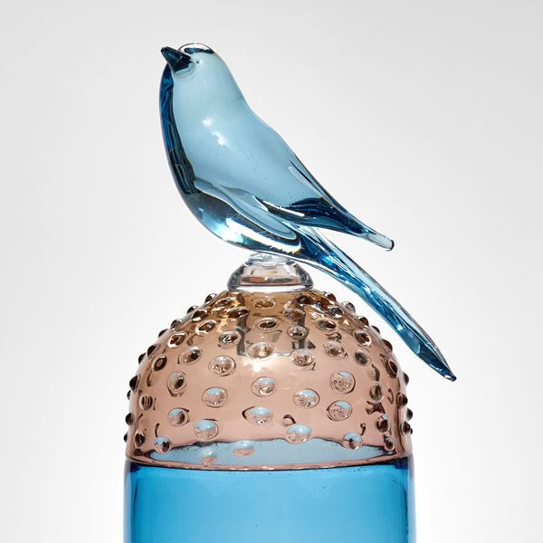 blue and soft bronze tall spotty domed lidded jar with blue bird on the top hand made from glass