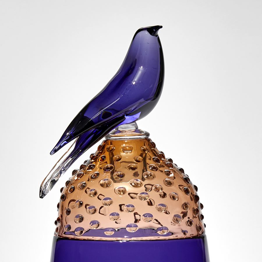 purple and bronze pear shaped jar with spotty domed lit with purple bird on top hand made from glass