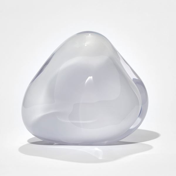 white soft rounded triangular sculpture with rich pick interior and front opening