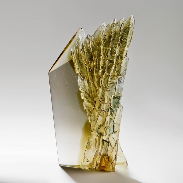 cast glass sculpture of rugged cliff edge in clear and dark colours