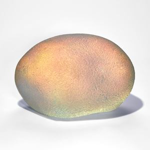 iridescent and gold coloured ovoid handmade glass sculpture with soft rock like texture