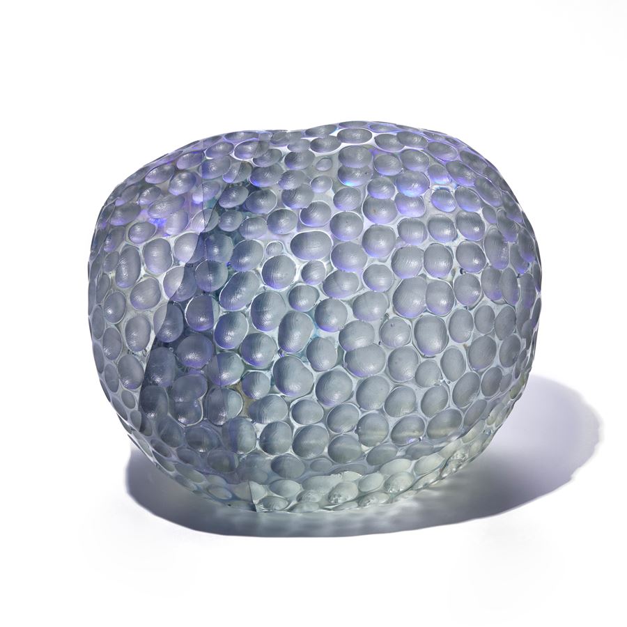 grey and purple depressed rounded sculpture with dimpled surface handmade from glass