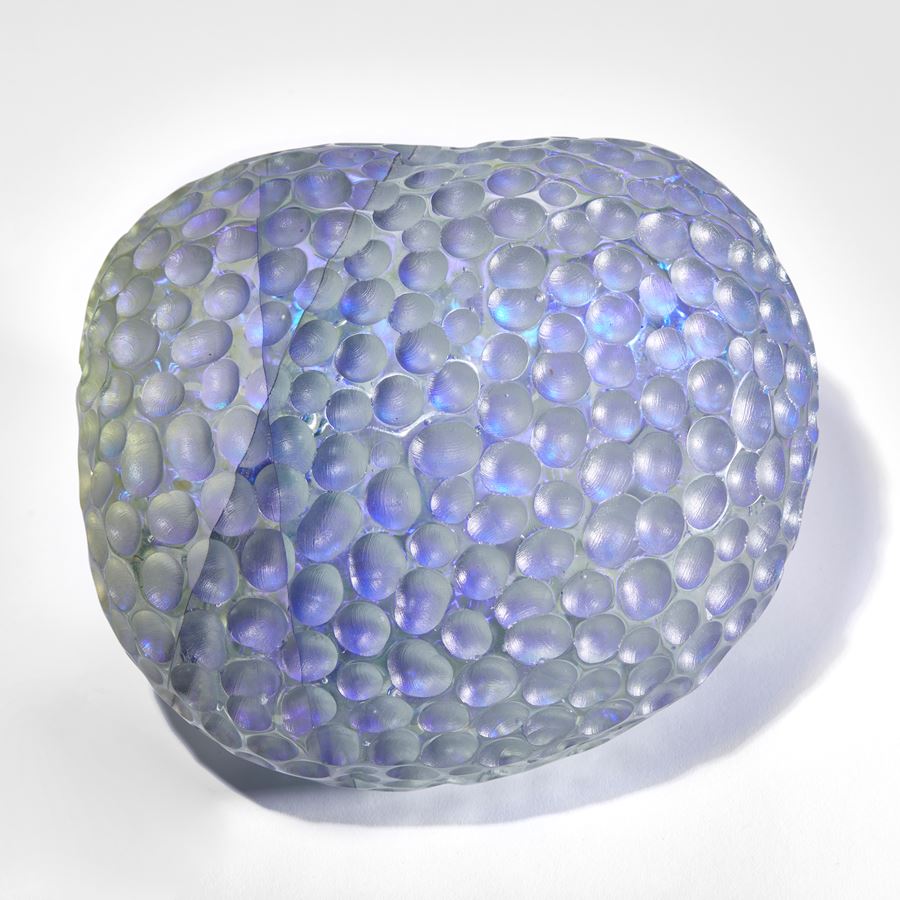 grey and purple depressed rounded sculpture with dimpled surface handmade from glass