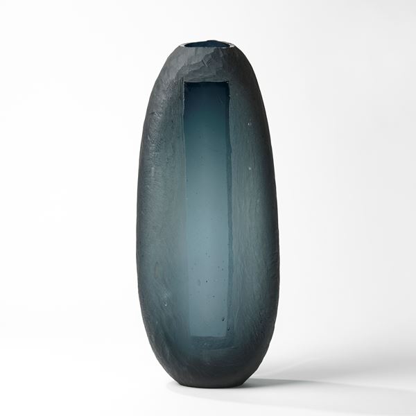 steel grey tall rounded vessel with central transparent rectangular window hand blown from glass