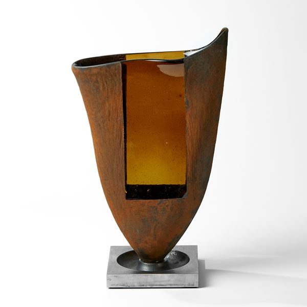 rich rust and amber flared vessel with opaque texture and transparent window on a steel base