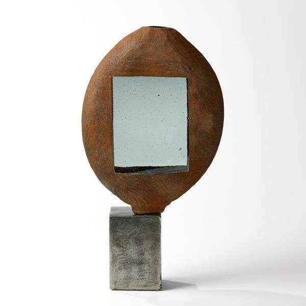 rust ovoid vessel with grey rectangular windows on a steel base handblown from glass