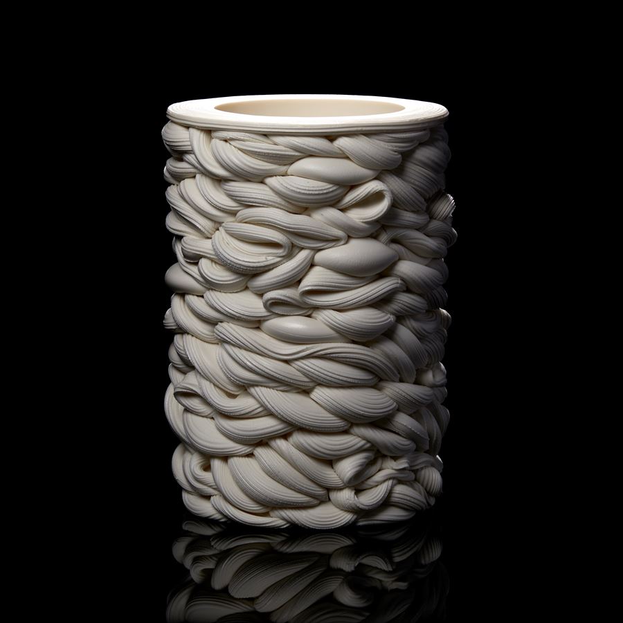 a cylindrical vessel of white thick twisting interwoven lines hand made from parian porcelain