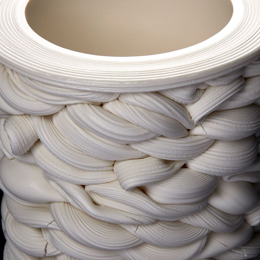 a cylindrical vessel of white thick twisting interwoven lines hand made from parian porcelain