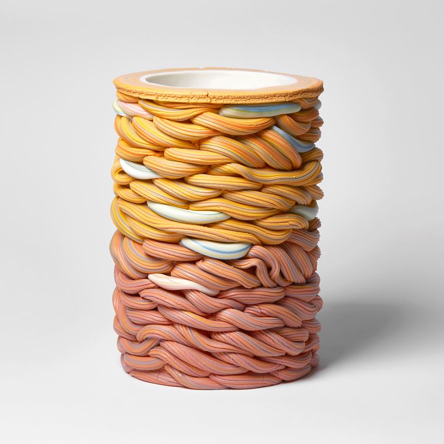 graduating from salmon pink to yellow with blue sections towering woven handmade ceramic vessel