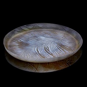 round shallow handmade glass platter in white and bronze with feather feather texture on the surface