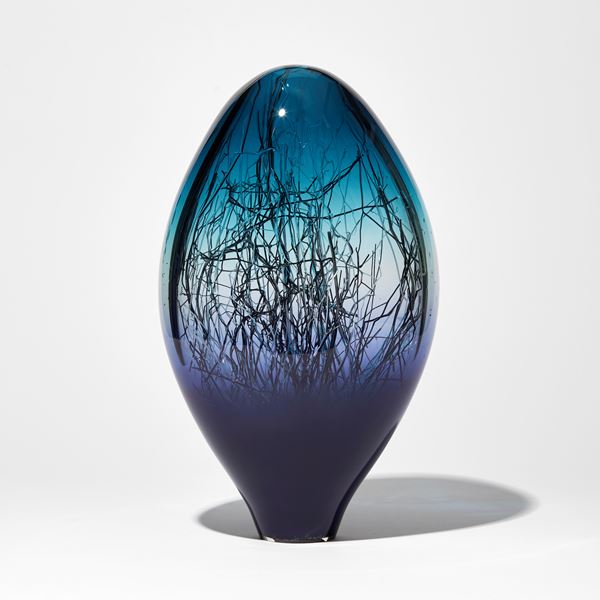 rich purplish blue and aqua coloured sculpture with interior fine dispersed black white and gold canes hand made from glass