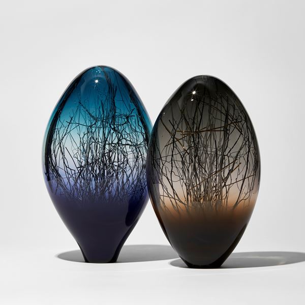rich purplish blue and aqua coloured sculpture with interior fine dispersed black white and gold canes hand made from glass