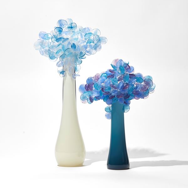 deep teal sculptural tree with simplified lollipop shaped leaves in blues purples and pinks handmade from glass