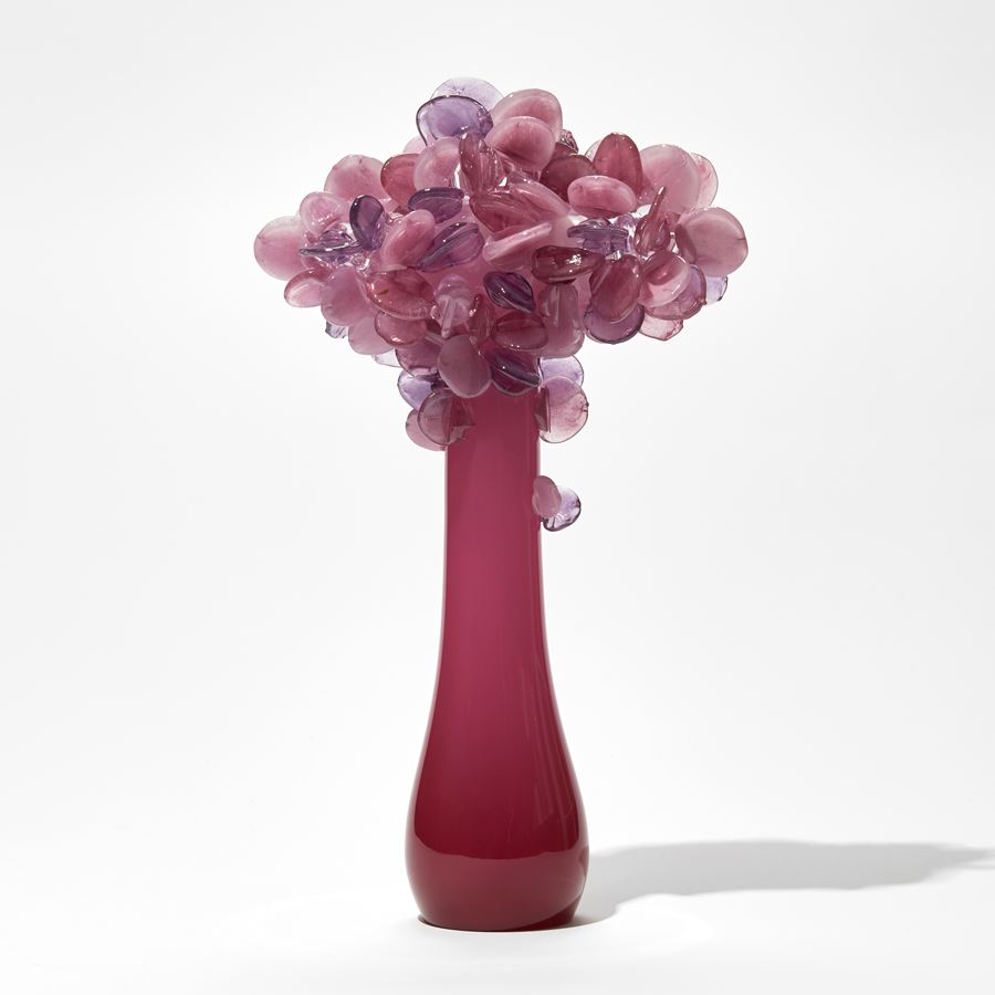 deep pink sleek stylised trunked tree sculpture with lollipop leaves in pink hues hand made from glass
