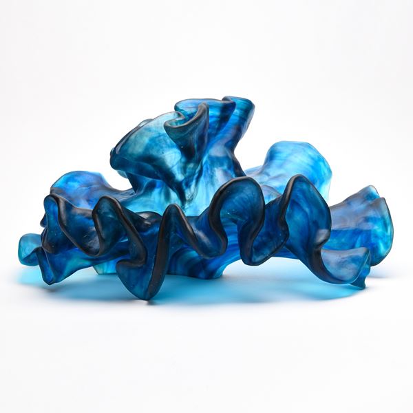 intense blue wavy and frilly sculpture hand made from cast glass