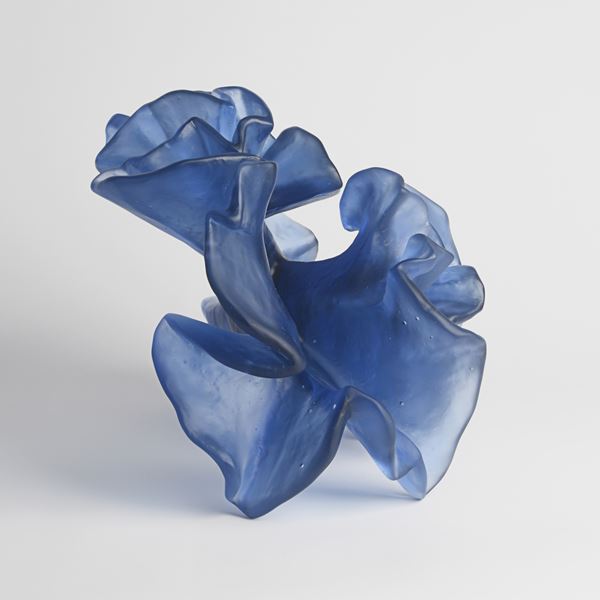 deep blueish purple crunched and frilled sculpture hand made from cast glass