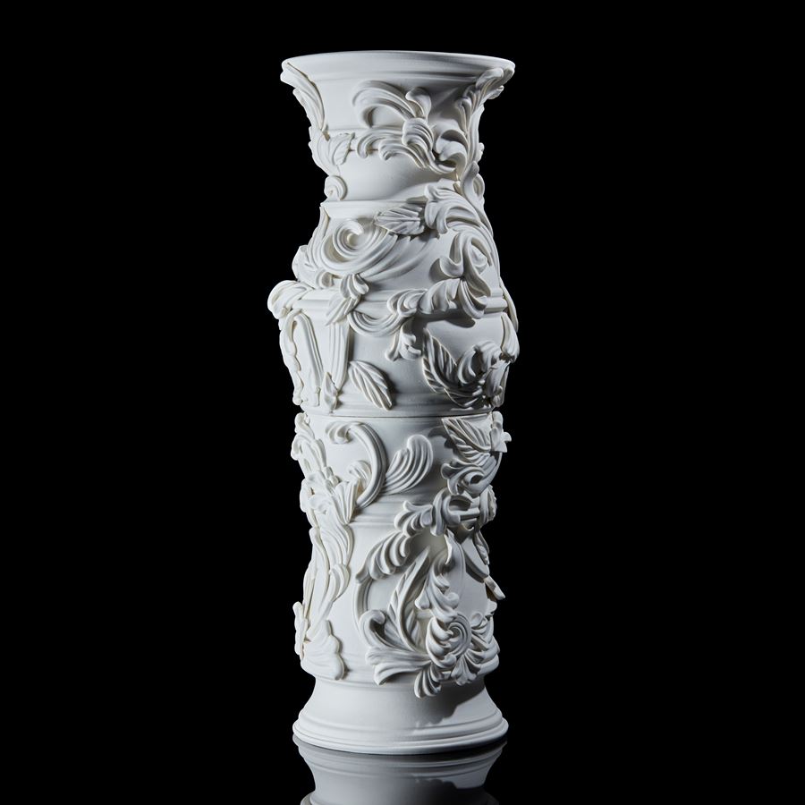white undulating column with organic flourishes and relief swirl details handmade and thrown from porcelain