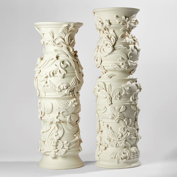 statuesque porcelain column covered in organic flourishes and relief leaf like swirling detail