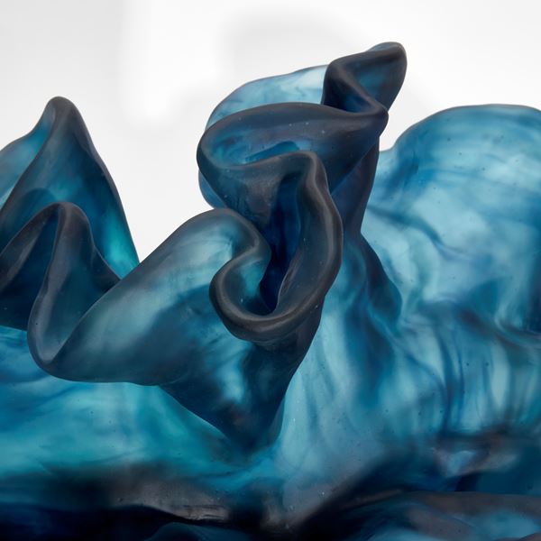 intense blue wavy and frilly sculpture hand made from cast glass