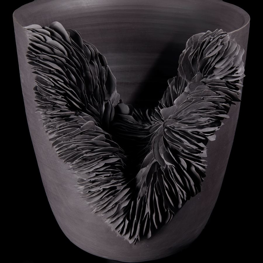 flared bowl with slashed front filled lined tiny shards handmade from black porcelain