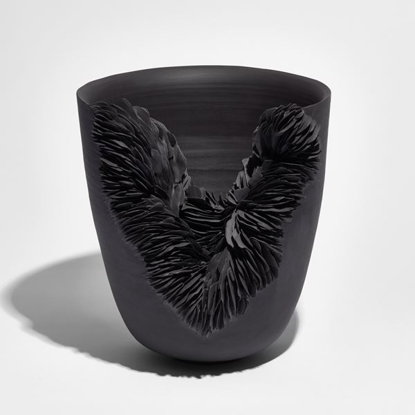 flared bowl with slashed front filled lined tiny shards handmade from black porcelain