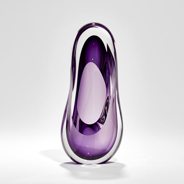 tall soft and rounded amorphous shaped sculpture in clear and purple hand made from glass