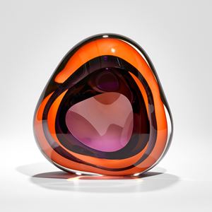 intense orange and purple amorphous shaped glass sculpture with front opening and internal soft cavity