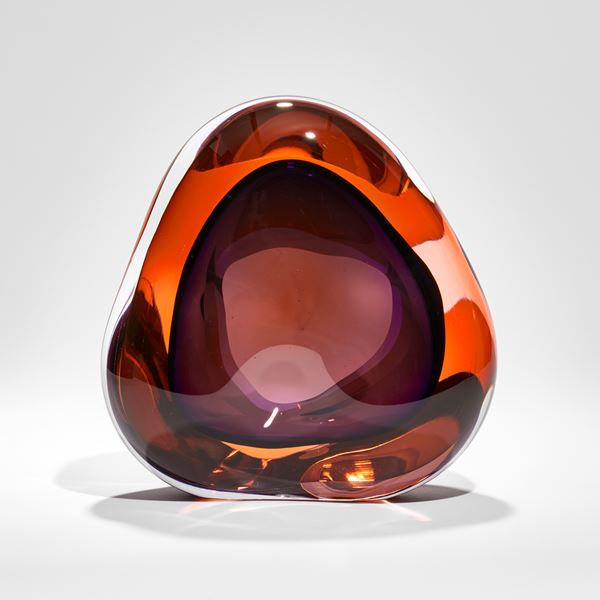 intense orange and purple amorphous shaped glass sculpture with front opening and internal soft cavity