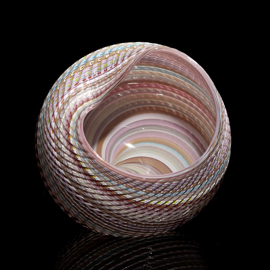 pastel coloured rounded simple shell like form with shiny interior and ridged cut exterior made from glass