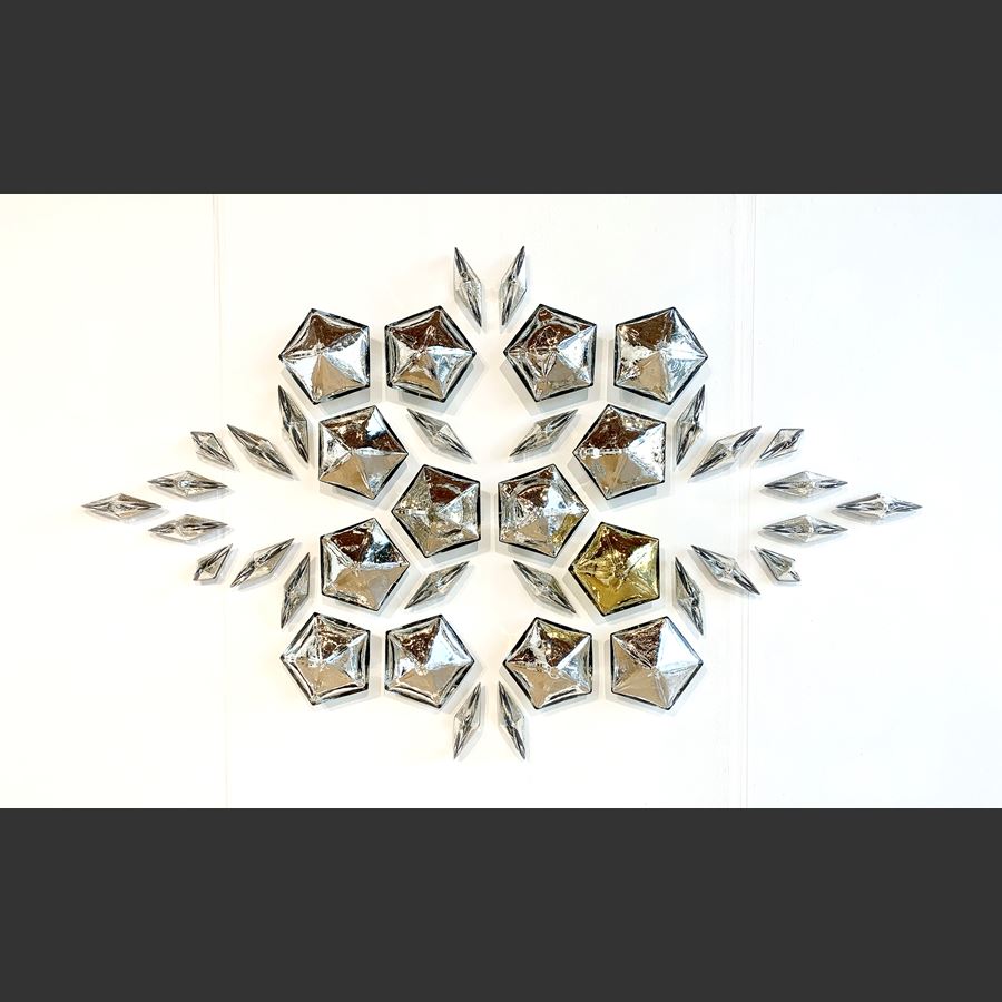 mirrors three dimensional pentagons and diamonds creating a unique pattern once hung on the wall hand made from blown glass