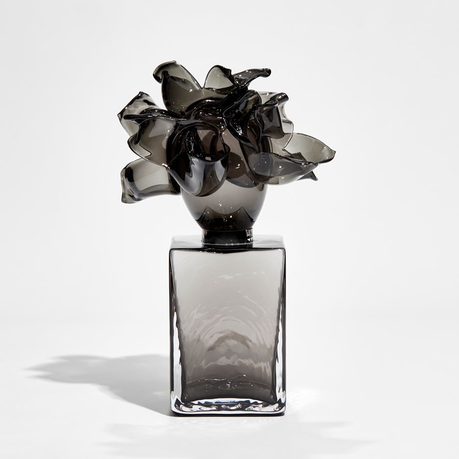 black and smokey grey box with floral explosive adornment on top handmade from glass 