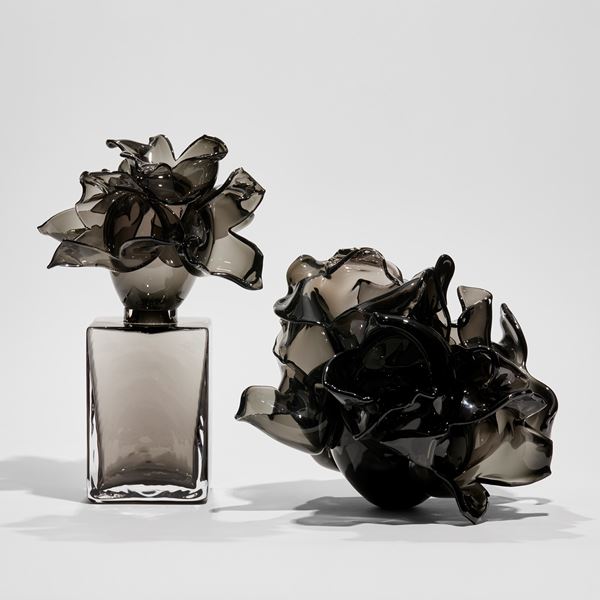 black and smokey grey box with floral explosive adornment on top handmade from glass 