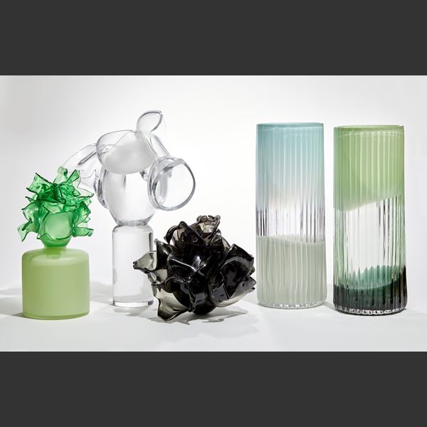 black flower vase with petals in different abstract organic shapes attached to a ovoid base hand made from glass