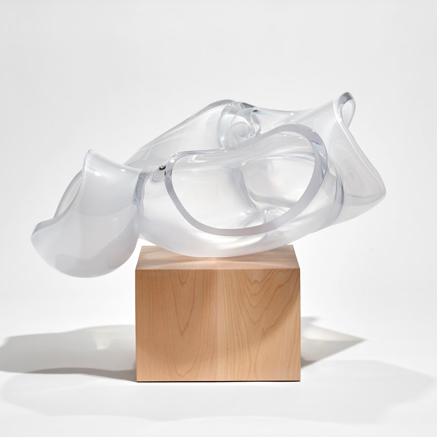 cube of birch wood with balanced abstract human heart aorta sculpture in clear and frosted glass hand made