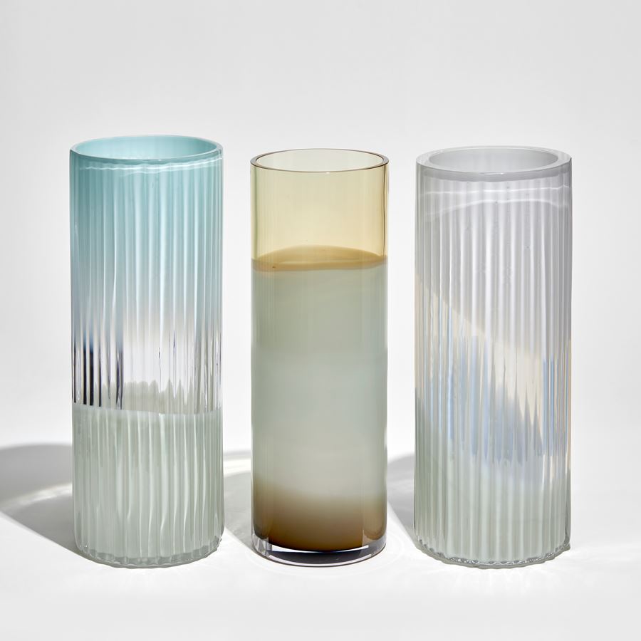 smooth cylindrical vase in abstract uneven bands of transparent amber opaque white and brown hand made from glass