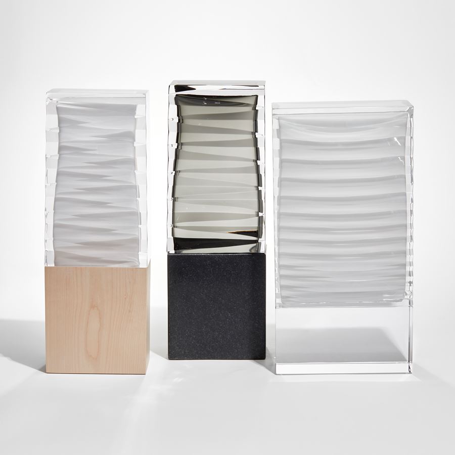 rectangular upright sculpture with birch base and white and clear glass top with inner folded origami detail