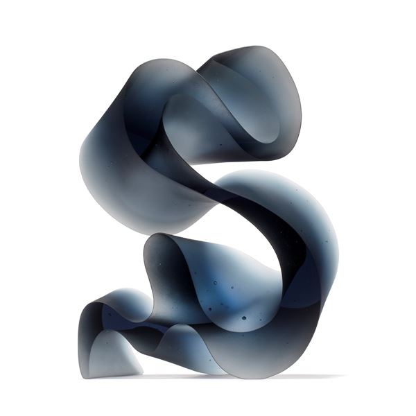 dark grey blue curved abstract ribbon lined sculpture hand made from cast glass standing on end