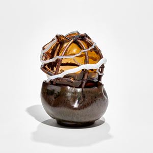 organic brown glazed bowl base with amber glass top bound in copper pipe with white glass trails