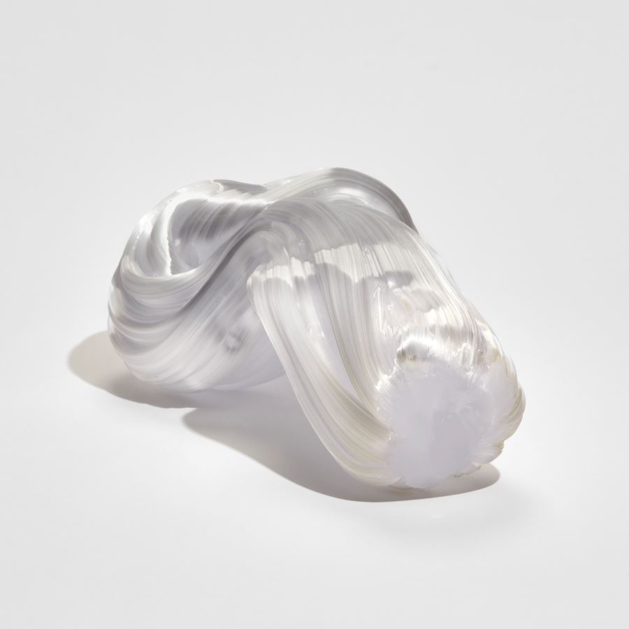 chunky bowed white glass sculpture with the appearance as if made from pulled sugar cane with a knot at one end
