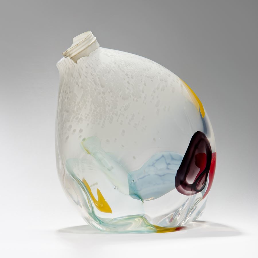 offset dew drop shaped vessel in white with patches of mixed colours and ocean plastic worn screw top cap