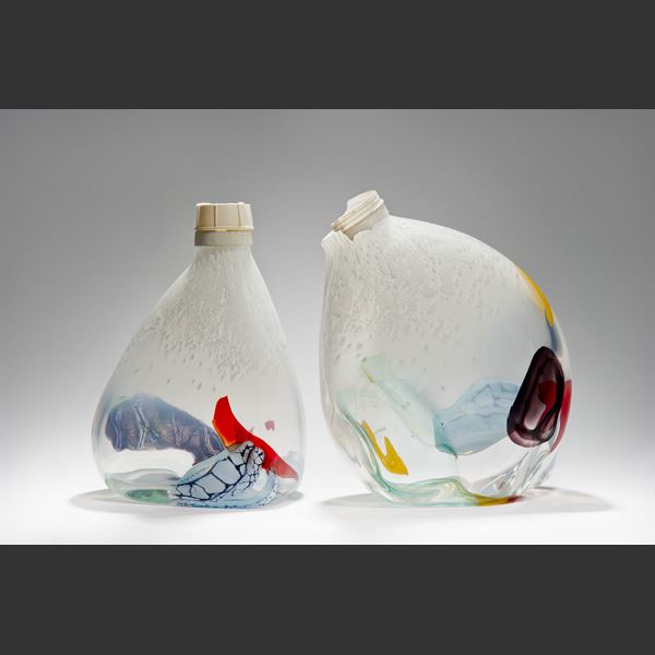 offset dew drop shaped vessel in white with patches of mixed colours and ocean plastic worn screw top cap