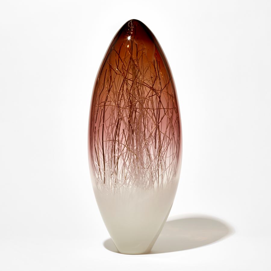 tall oval sculpture with soft off white base and rich aubergine top with trapped fine canes of white and gold inside hand made from glass